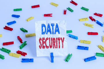 Text sign showing Data Security. Business photo showcasing Confidentiality Disk Encryption Backups Password Shielding Colored clothespin papers empty reminder white floor background office