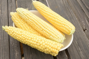 kidneys of raw corn lie on a dark wooden background