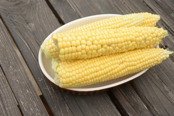 kidneys of raw corn lie on a dark wooden background