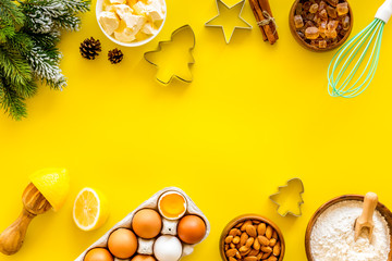 Kitchen frame. Dough ingredients and crockery on yellow background top view copy space