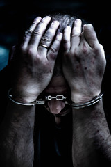 Upset handcuffed man imprisoned for crime, punished for serious villainy. Arrest, gangster, pain...