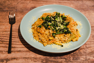 vegetables risotto with kale and vegan cheese topping