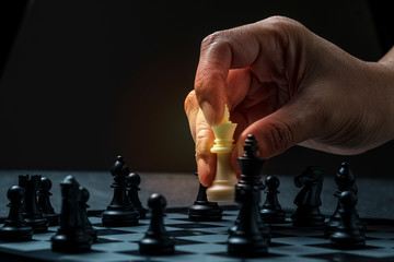 A hand of man is playing chess 