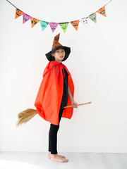 Asian girl with witch costume, halloween concept.