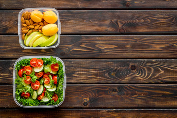 Lunch box for food to go with healthy meal on wooden background top view mock up
