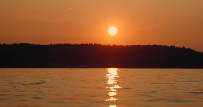 Red sunset on the lake slow motion