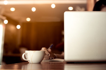 cup of coffee and laptop on the table.