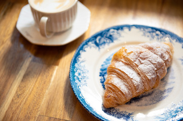 coffee and bake on wood table background. 