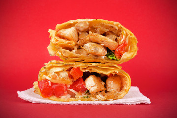Fast food concept : chicken shawarma on a red background