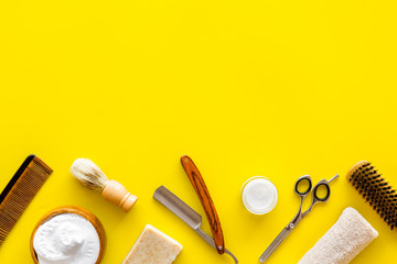 Men's shaving accessories on yellow background top view copy space