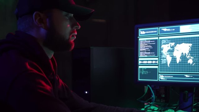 Wanted hackers coding virus ransomware using laptops and computers. Cyber attack, system breaking and malware.