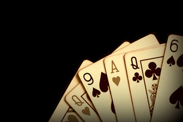 Playing cards on a dark background close up. Retro style