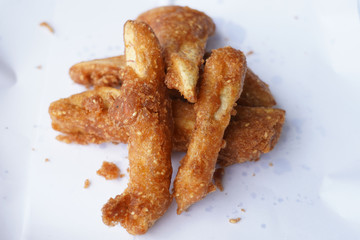 Banana fry in a pan with boiling oil. When finished, looks very appetizing