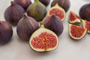 Fresh figs. Whole figs and sliced in half figs in ceramic bowl.