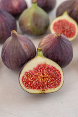 Fresh figs. Whole figs and sliced in half figs in ceramic bowl.