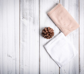 Woman panties set on white wooden background,top view