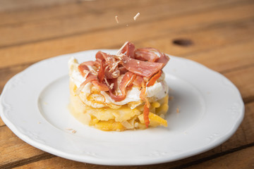 Spanish tapa, potato, fried egg, bacon and foie