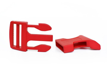 Single opened red quick side release plastic buckle isolated on white background