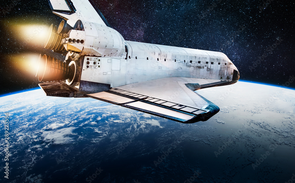 Leinwandbilder Space shuttle in dark outer space near Earth. Rocket on orbit of the planet. Elements of this image furnished by NASA