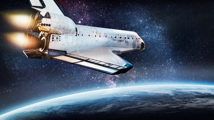 Space shuttle rocket in outer space over Earth planet. Ocean and clouds on surface. Sci-fi...