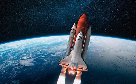 Space shuttle launch in outer space from Earth. Rocket on orbit of the planet. View from space station. Elements of this image furnished by NASA	