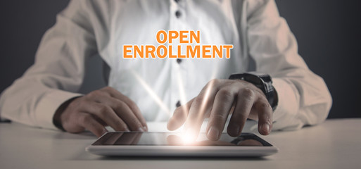 Man using tablet computer. Open Enrollment