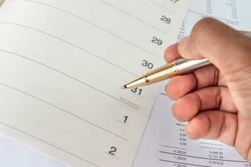 The calendar in the notebook on the desk