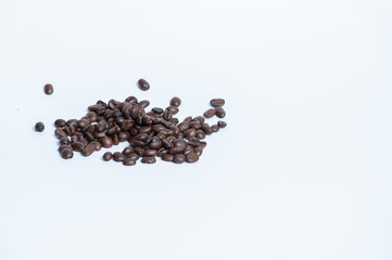Arabica roasted coffee beans placed on a white background