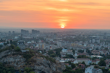 Beautiful sunrise with pink and yellow clouds above Plovdiv city 
