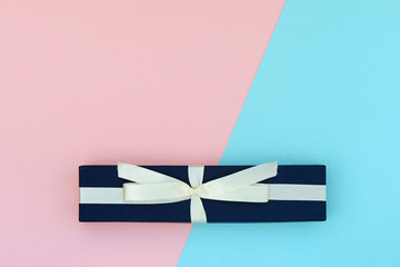 Beautiful gift box on a pink and blue background. Flat lay top view copy space