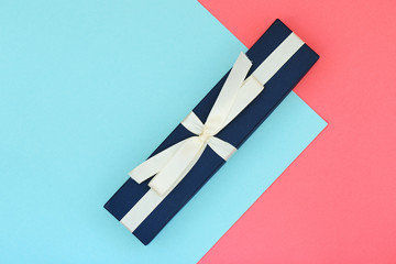 Beautiful gift box on a pink and blue background. Flat lay top view copy space