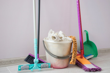 House cleaning with mop, cleaning equipment at the wall. MOP, bucket, dustpan, rag
