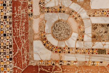 Decorative Beautiful Geometric Old Mosaic Stone Wall Background. Colorful Composition of Symbols Tiled Ornament CloseUp. Macro Photo of Original Fresco of Colored Ceramics Material