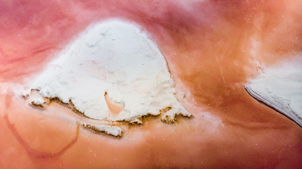 Amazing drone panoramic aerial landscape of beautiful salt plains. pink lake. Bright red salt deposits in artificial salt evaporators, salt mining