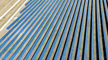 solar panels, desert. Solar energy farm. Top view of solar panels on the energy farm. Aerial view of the solar power plant. Industrial background on renewable resources.  large photovoltaic complex