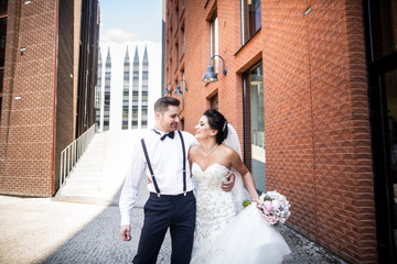 Bride and groom walking in the city, wedding day, marriage concept. Bride and groom in urban...