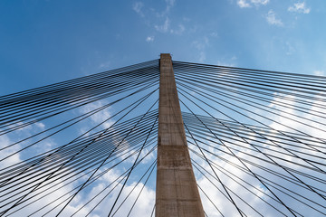 Modern suspension bridge. Detail of tower and steel cables