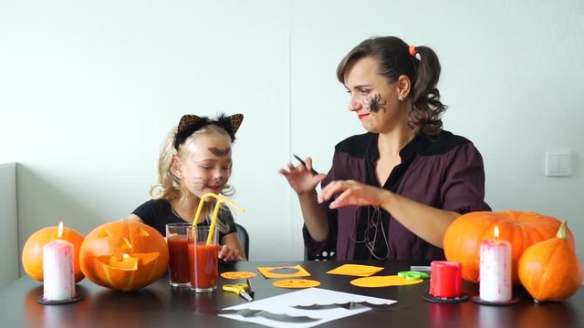 Cute Little Girl and her Mother Having Fun while Preparing for a Halloween Celebration. Halloween Holiday Concept