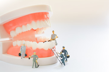 Miniature people, small model human figure clean model teeth with copy space. Medical and dental...