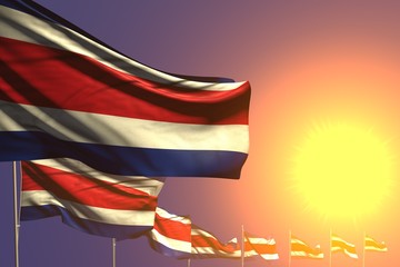 pretty many Costa Rica flags placed diagonal on sunset with space for content - any occasion flag 3d illustration..
