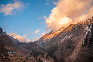 Fototapeta premium orange color sunset landscape with snow mountain