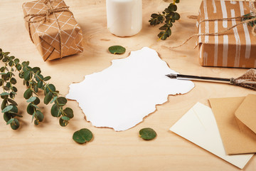 Seasonal letter with a vintage feather quill pen on wooden background