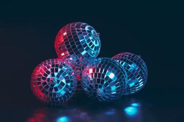 Group of shiny Disco Balls on dark background close up