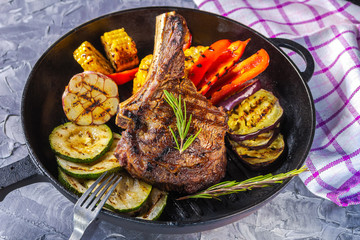 Juicy steak and grilled vegetables in a pan. Life style.
