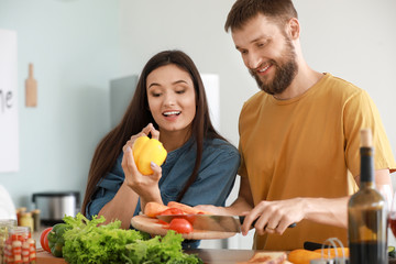 Young couple cooking together in kitchen