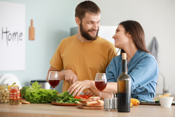 Young couple cooking together in kitchen