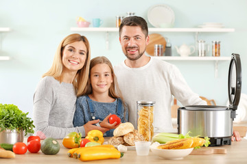 Happy family with modern multi cooker in kitchen