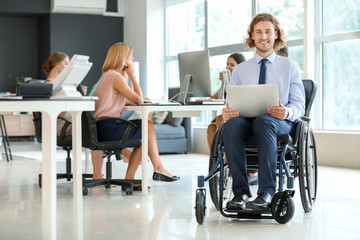 Handicapped young man working in office