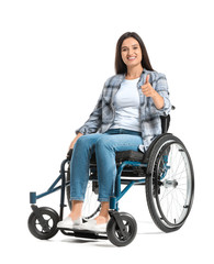 Fototapeta na wymiar Happy woman in wheelchair showing thumb-up gesture on white background
