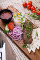 Grilled lamb kebab served with rice garnish and vegetables